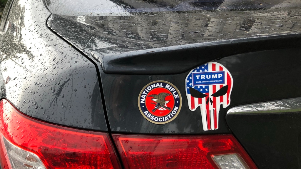 Photo of skull sticker next to NRA sticker on car